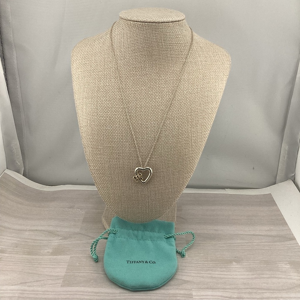 Tiffany & Co. 9.25 S.Silver with 750 Yellow Gold Bow Heart Pendant Necklace.
